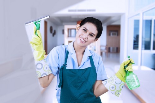 Cleaner wearing PPE while treating a carpet area safely
